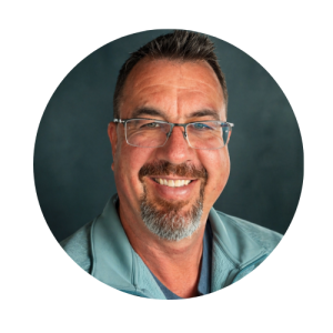 smiling man with facial hair and glasses